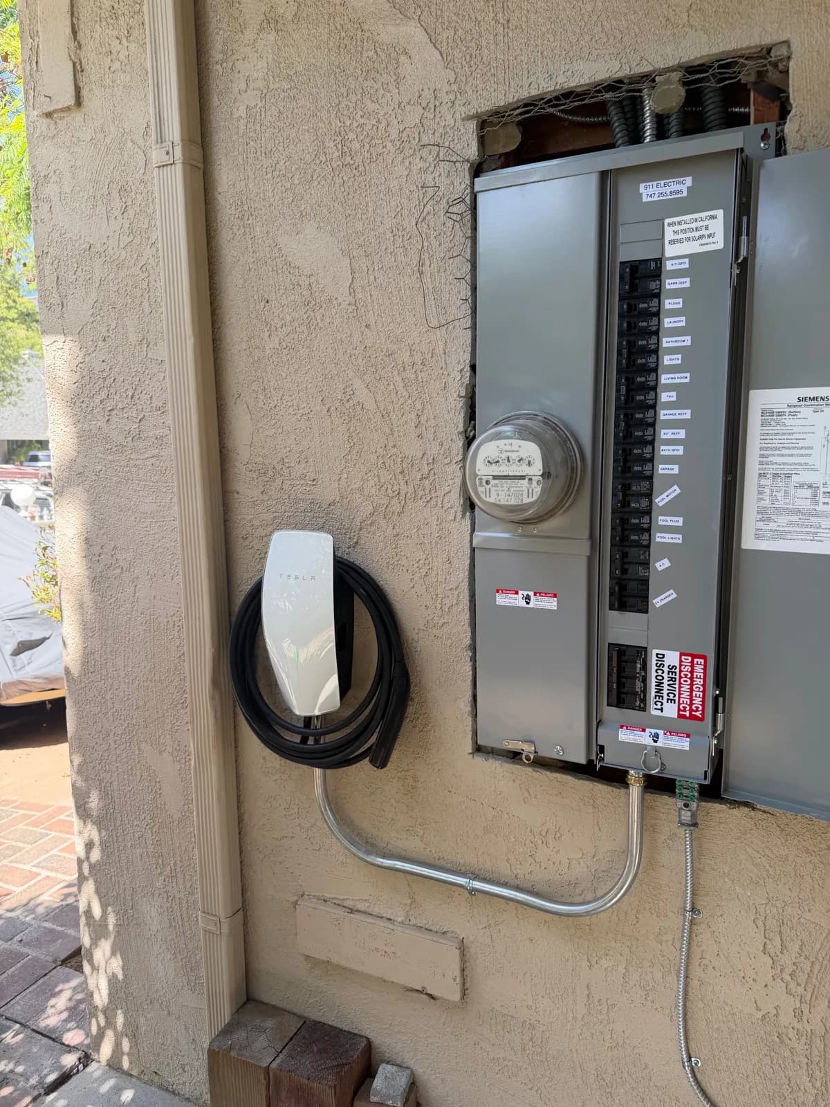 A Tesla Wall Connector and electrical panel installation by our crew
